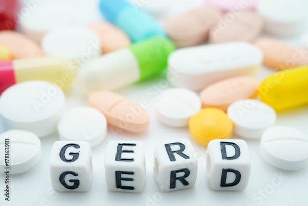 Fototapeta GERD Gastro esophageal Reflux Disease word with pills and capsules medical drug.