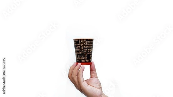 Obraz Isolated hand holding paper coffee cup with black lid. Enjoying takeaway coffee with stylish cup