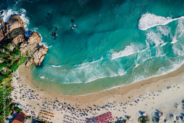 Fototapeta Joaquina beach with rocks and ocean with waves in Brazil. Above view