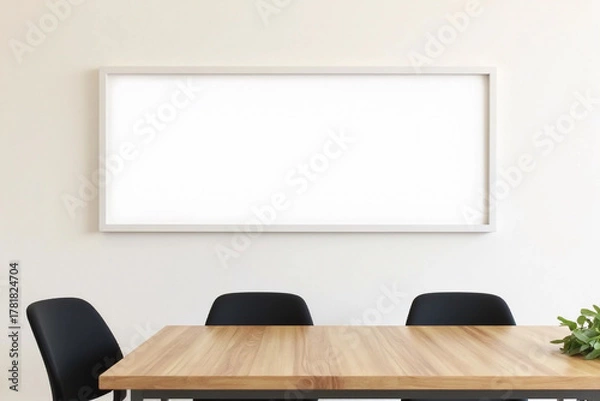 Fototapeta Empty white blank long horizontal rectangle frame, mockup artwork or picture frames, hanging on clean plain wall above three black chairs and wooden table in meeting room.