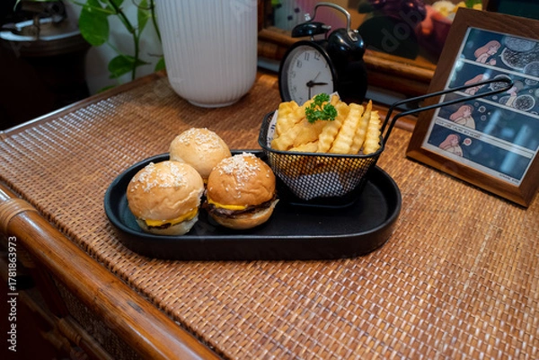 Fototapeta A delightful presentation of mini burgers and fries on a serving tray