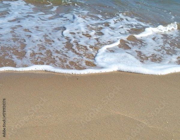 Obraz Ocean tide washing sandy shore showing movement of natural marine environment