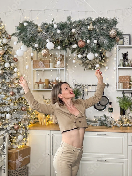 Obraz closeup portrait of smiling beautiful senior Caucasian woman with happy face. cheerful woman sits in front of a decorated Christmas tree.