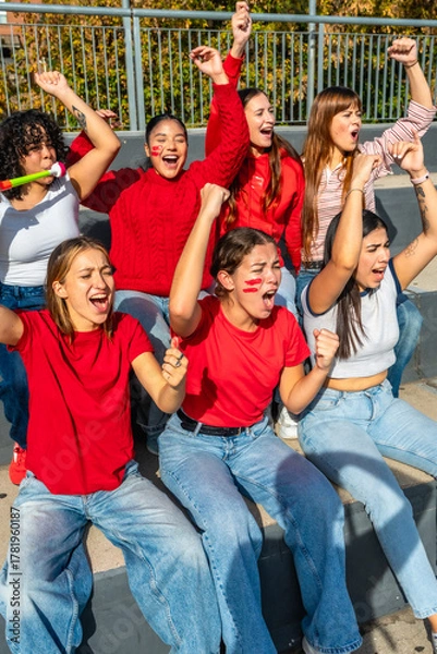 Fototapeta Female sport fans celebrating team victory at stadium