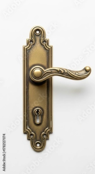 Obraz Antique Door Handle with Ornate Design on White Door
