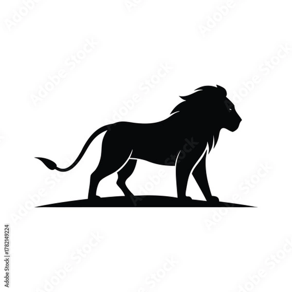 Fototapeta Black silhouette of a majestic lion standing on a grassy mound