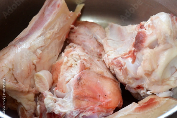 Obraz several pieces of raw beef bones in a pot, being prepared for making bone broth, bone marrow soup or stock, Bone broth is a nutrient-dense liquid made by simmering animal bones in water