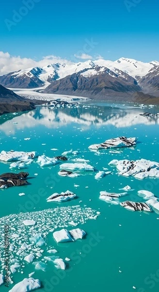Obraz Stunning Aerial View of a Turquoise Glacier Lake with Floating Icebergs and Snow-Capped Mountains.