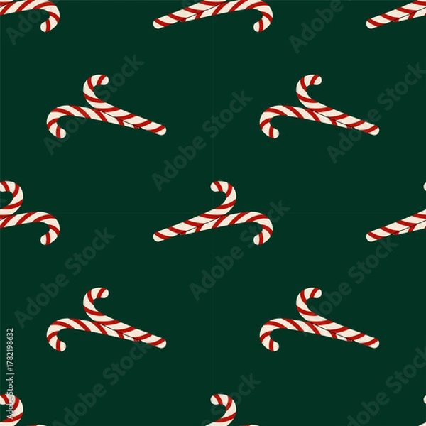 Fototapeta Festive seamless pattern with striped candy canes on dark green background. Christmas background. For wrapping paper, textiles or holiday design.