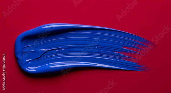 Obraz Blue Brushstroke on Red Background with Textured Paint