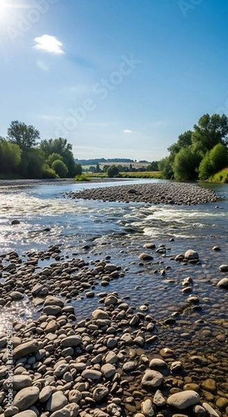 Fototapeta River Flowing Through Rocky Bed on Sunny Day.