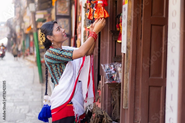Obraz Newari Girl in Traditional Attire Strolling Through Patan Durbar Square