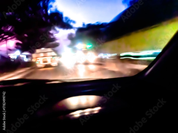 Fototapeta The glossy, reflective surface reflects intense light with a spectrum of bright colors such as purple, orange, and green, creating a dynamic and surreal abstract scene.