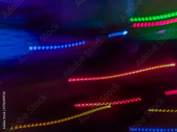 Fototapeta Elegant neon colored lines of light cut through the darkness of the night, giving a futuristic and dynamic impression of speed and movement, like a stunning digital abstract painting