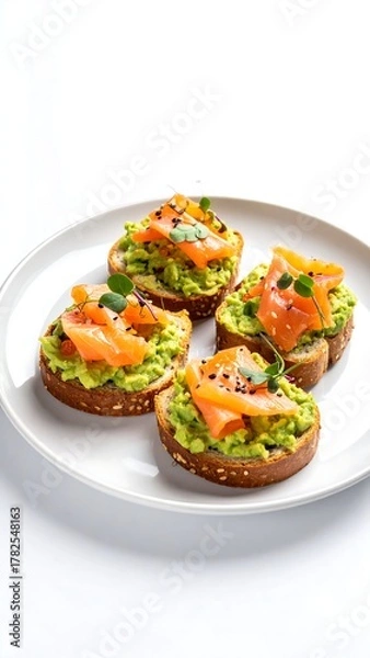 Fototapeta Delicious Avocado Toast with Smoked Salmon Appetizers on White Plate.