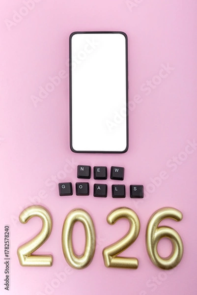 Fototapeta Smartphone with number 2026 and black keys on pink background. Concept of planning new digital goals and future motivation. Vertical photo, mock-up