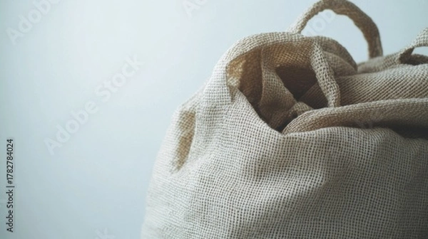 Fototapeta A tan bag with a white handle. The bag is open and has a white interior