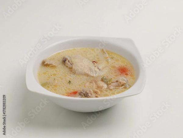 Fototapeta Garang Asem is chicken cooked in coconut milk with spices and tamarind, bilimbi or lime 