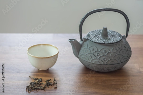 Obraz Image of traditional eastern teapot and teacups on wooden desk 