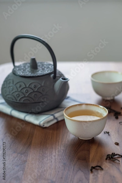 Obraz Image of traditional eastern teapot and teacups on wooden desk 