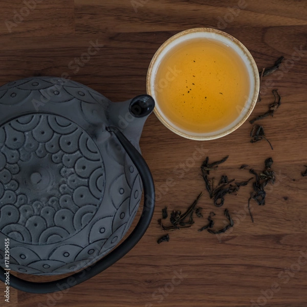 Fototapeta Image of traditional eastern teapot and teacups on wooden desk 