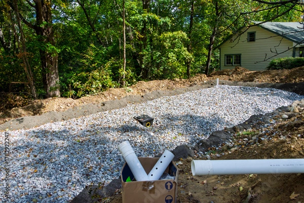 Fototapeta Home septic system leach field in progress with crushed stone layer, and the distribution box waiting for the input pipe
