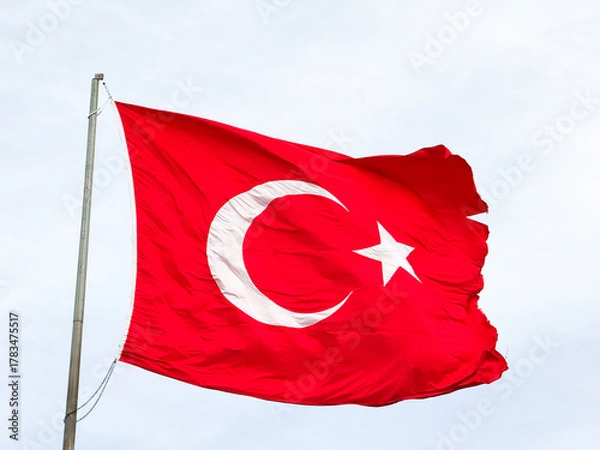 Fototapeta Turkish national flag waving in the wind against cloudy sky
