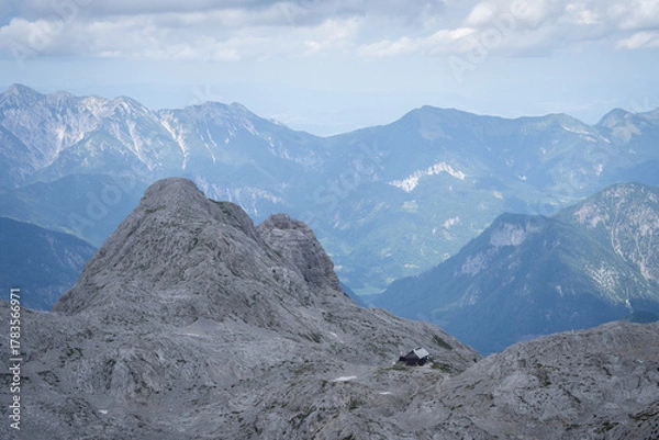 Fototapeta Landscape with solitary mountain hut located on a rocky alpine terrain, Triglav Nat Park, Slovenia