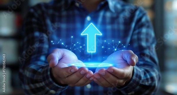 Fototapeta Person Holding a Glowing Digital Arrow Symbolizing Growth and Progress.