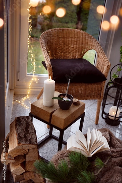 Fototapeta Cozy reading nook with comfortable furnishings and natural light. Vertical background for leisure and relaxation.