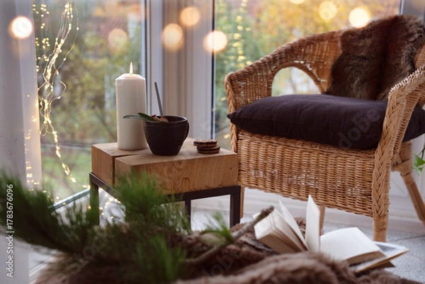 Fototapeta Cozy reading nook with comfortable furnishings and natural light. Background for leisure and relaxation.