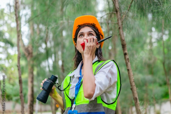 Fototapeta Female Environmental Surveyor Observing Forest Ecosystem