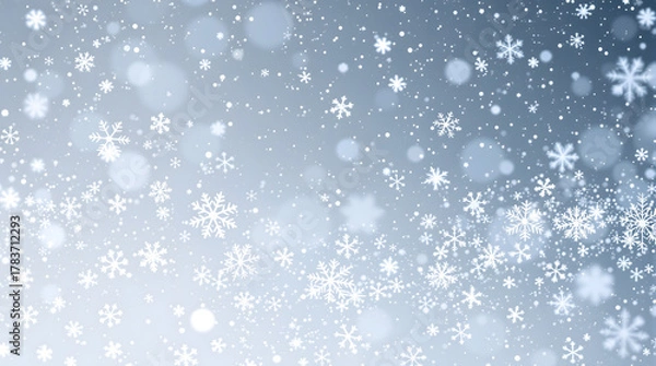 Obraz Winter Wonderland: An ethereal scene of delicate snowflakes cascading gently against a soft blue and silver backdrop, evoking a sense of tranquility and the magic of winter.