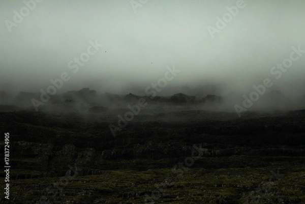 Obraz Mysterious mountain wrapped in fog in the Faroe Islands, showcasing the wild beauty of the North Atlantic and inviting hiking adventures.