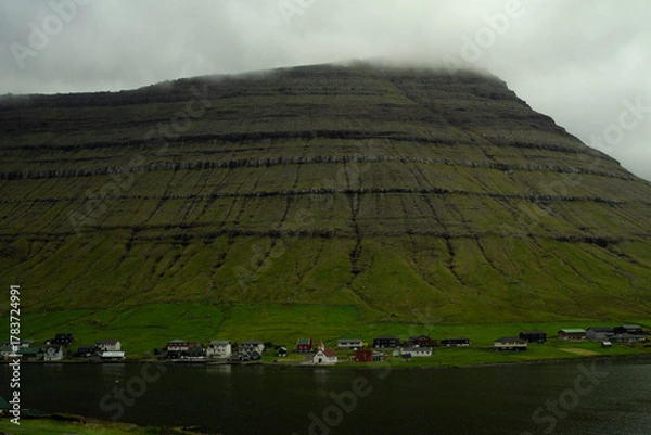 Obraz Peaceful view of Kunoy village surrounded by steep mountains and the North Atlantic — a hidden gem for hikers and travelers in the Faroe Islands.