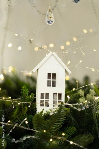 Obraz White decorative house with fairy lights and fir branches