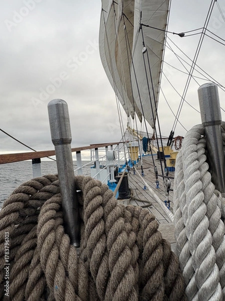 Fototapeta rigging and sails on the bowsprit of a tall ship