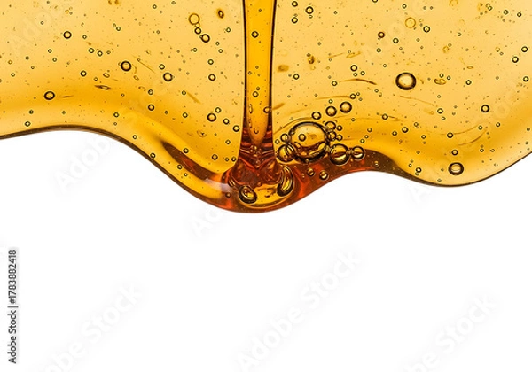 Fototapeta Viscous golden honey pouring and dripping with air bubbles forming a wavy line isolated on transparent background