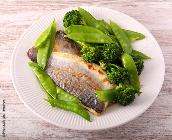Fototapeta sea bass fillets with snap peas and broccoli