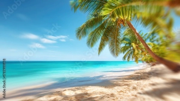 Fototapeta White sand stretches along the shore as palm trees sway gently in the breeze. The turquoise ocean sparkles under a bright blue sky, creating a perfect tropical paradise.