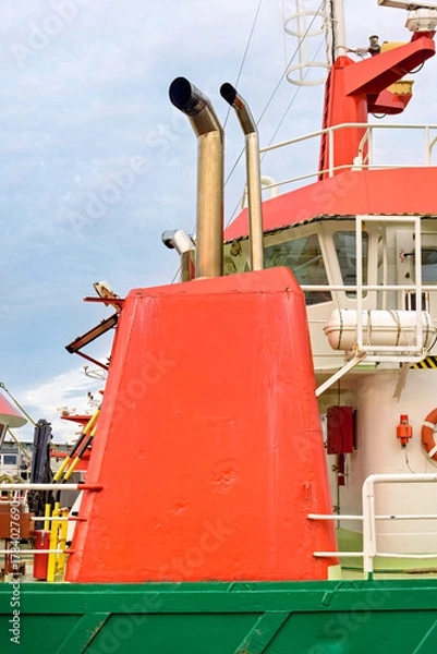 Obraz orange chimney with two exhaust pipes on the deck of a boat