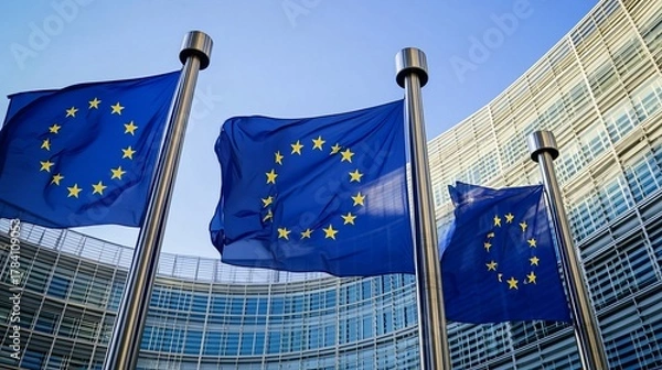 Fototapeta EU flags waving before modern building