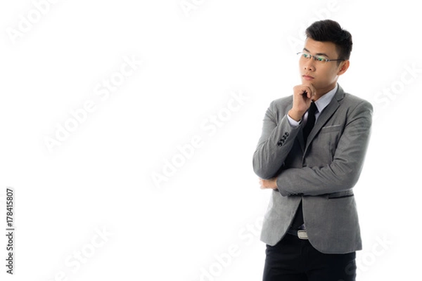 Fototapeta Portrait of a business man thinking with suit. Isolated on white background with copy space