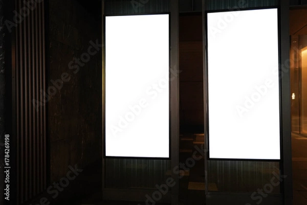 Fototapeta Street advertising mockup template with copy space. Two outdoor commercial banners with white empty display on the night street