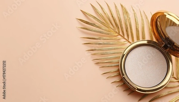 Obraz Gold compact powder with palm leaf on peach background