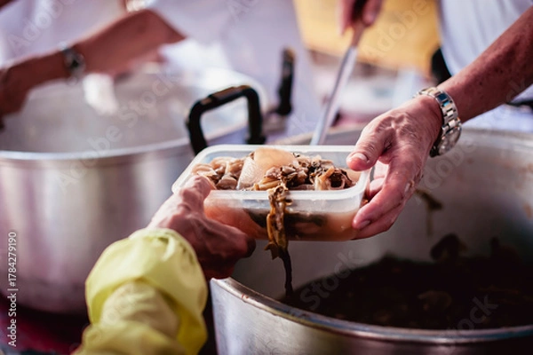 Fototapeta volunteers give food to local poor people, Feeding the poor Help them relieve hunger