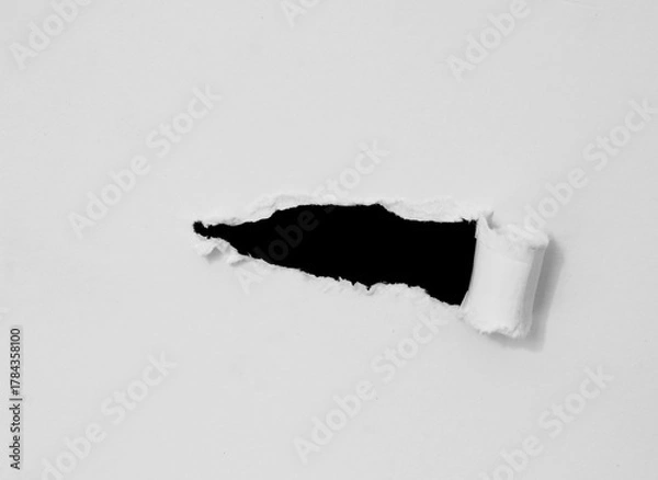 Obraz ripped paper on black background.