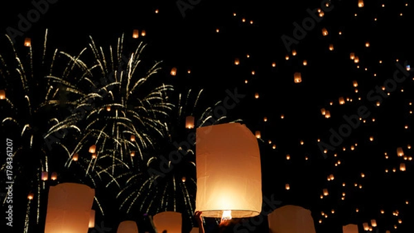 Obraz hundreds of paper lanterns glowing in the night sky during yi peng festival in chiang mai, thailand, as warm flames lift them gently, symbolizing wishes and letting go.