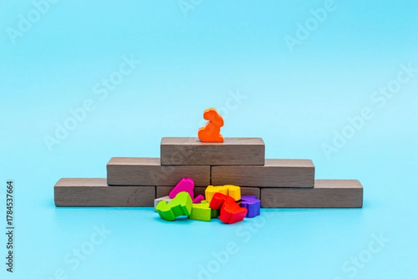 Fototapeta The winner stands on a pedestal above the defeated competitors and enemies, concept