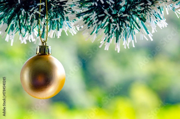 Obraz Golden Christmas ball with customizable space for text or wishes. Christmas celebration concept.